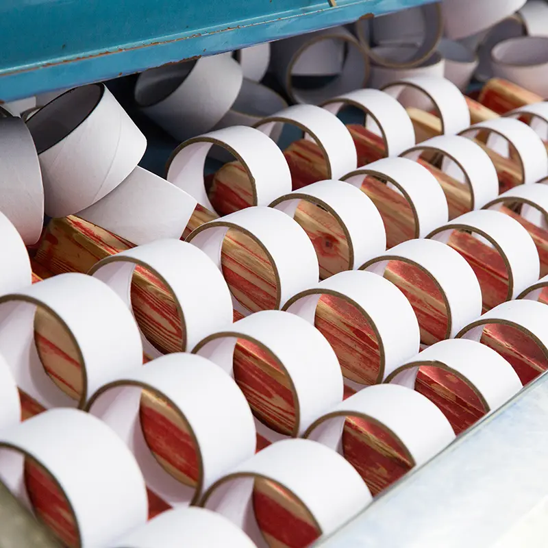 Detailed photos of straight tubes of tape being cut into small rolls (1)