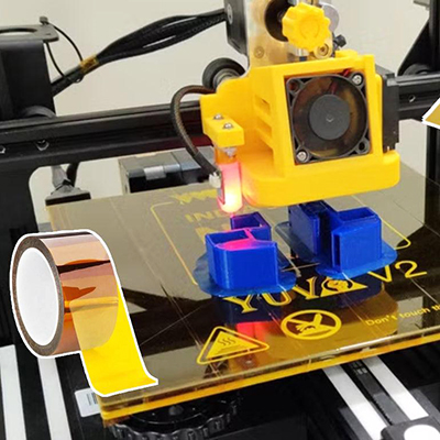 Polyimide Kapton tape applied on a 3D printer heated bed for print adhesion and thermal protection.