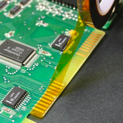 Polyimide Kapton tape applied on PCB gold fingers for high-temperature soldering protection.