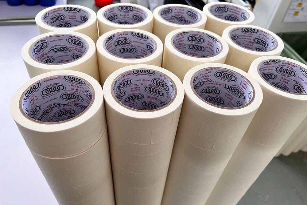 High-volume finished masking tape rolls stacked with custom printed paper inner cores